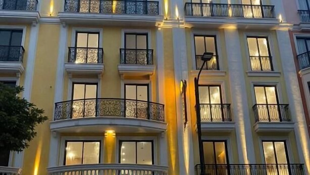 A hotel with a classical facade, multiple balconies, and large windows. - Elysees Hotel (Sam Son)