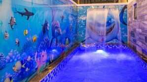 An indoor swimming pool with a shark mural on the wall. - Elysees Hotel (Sam Son)