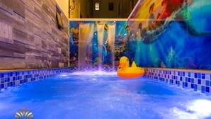 A hot tub with a colorful mural and a duck float. - Elysees Hotel (Sam Son)