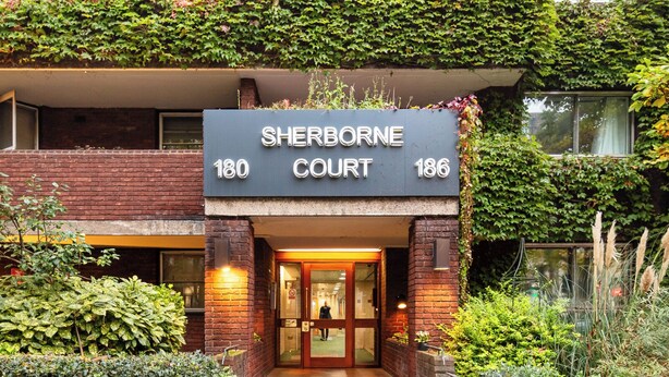 A multi-story building with a sign reading "Sherborne Court 180 186".