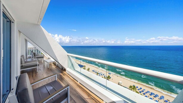 A balcony with a view of the ocean and beach. - Holiday Waves: Oceanview Charm at Central Beach (Fort Lauderdale)