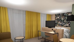 A hotel room with a bed, a desk with a computer, a TV, and a sofa. - Thon Hotel Straume (Oygarden)