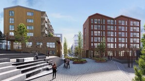 A modern urban plaza with steps leading to a building with a wooden facade and a red brick building with multiple windows. - Thon Hotel Straume (Oygarden)