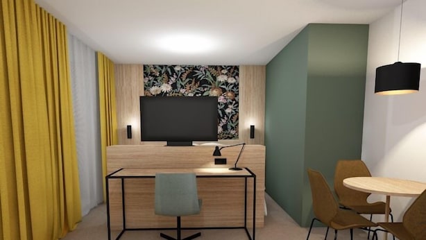A modern hotel room with a wooden desk, a flat-screen TV, a desk lamp, a chair, a small dining table with chairs, and a yellow curtain. - Thon Hotel Straume (Oygarden)