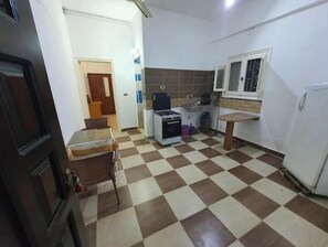 Enjoy meals in the kitchen with a dining table and chair, a stove, and a sink.