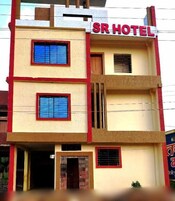A multi-story building with a sign reading 'SR HOTEL' at the top.
