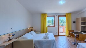 A hotel room with a bed, a desk, and a view of the outdoors. - countryside  3 - One Bedroom Guest House, Sleeps 2 (Carbonia)
