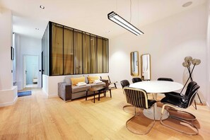 Relax in this inviting space with a sofa, armchair, and dining table for meals or gatherings.