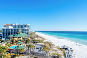 A beachfront hotel with a pool, beach access, and a view of the ocean. - Beachfront Wraparound Balcony (Miramar Beach)