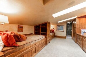 Relax in this inviting room with a large bed, storage, and a cozy bench.