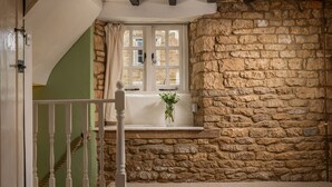 A room with a stone wall, a window with white shutters, and a white railing. - Wyck Cottage - pet friendly in Wyck Rissington near Bourton-on-the-Water (near Bourton-on-the-Water)