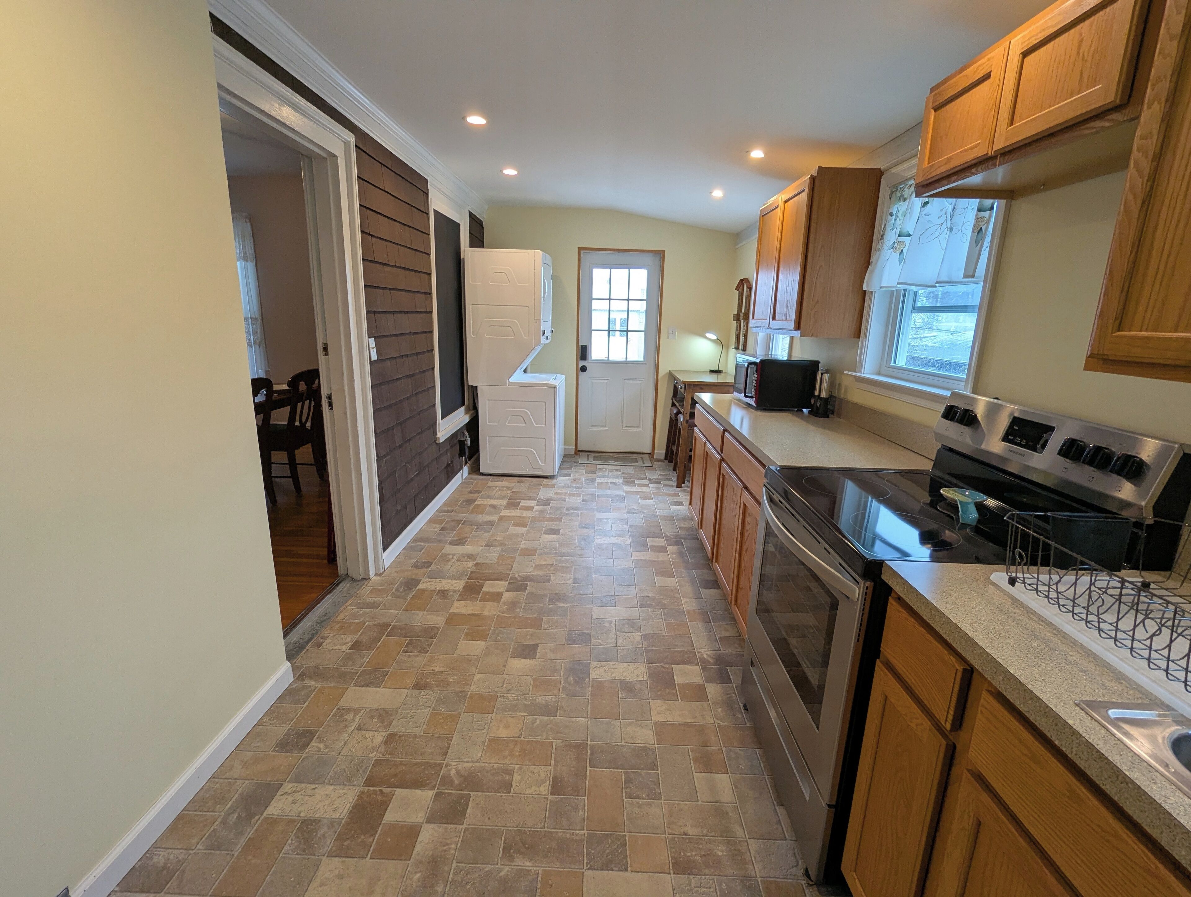 View of entrance door from the other end of the kitchen