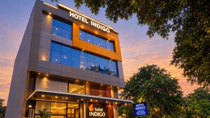 A modern hotel building with a prominent sign reading 'HOTEL INDIGO.' - Hotel Indigo (Indore)