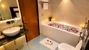 A modern bathroom with a freestanding bathtub, a sink, and a toilet. - Hotel Indigo (Indore)