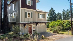 A two-story house with a garage, a balcony, and a front door. - 3 BDR Home in Gualala w/ Ocean Views for 6! (Gualala)
