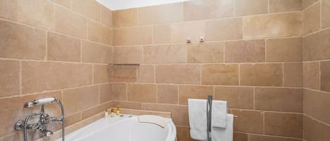 A bathroom with a bathtub, a shower, and a toilet.