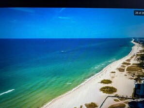An aerial view of a beach with clear turquoise waters, a sandy shoreline, and a few buildings along the coast. - Clean & Cozy 1BR • Budget-Friendly • Close to Beach, free Wifi and Parking. # 1 (Pompano Beach)
