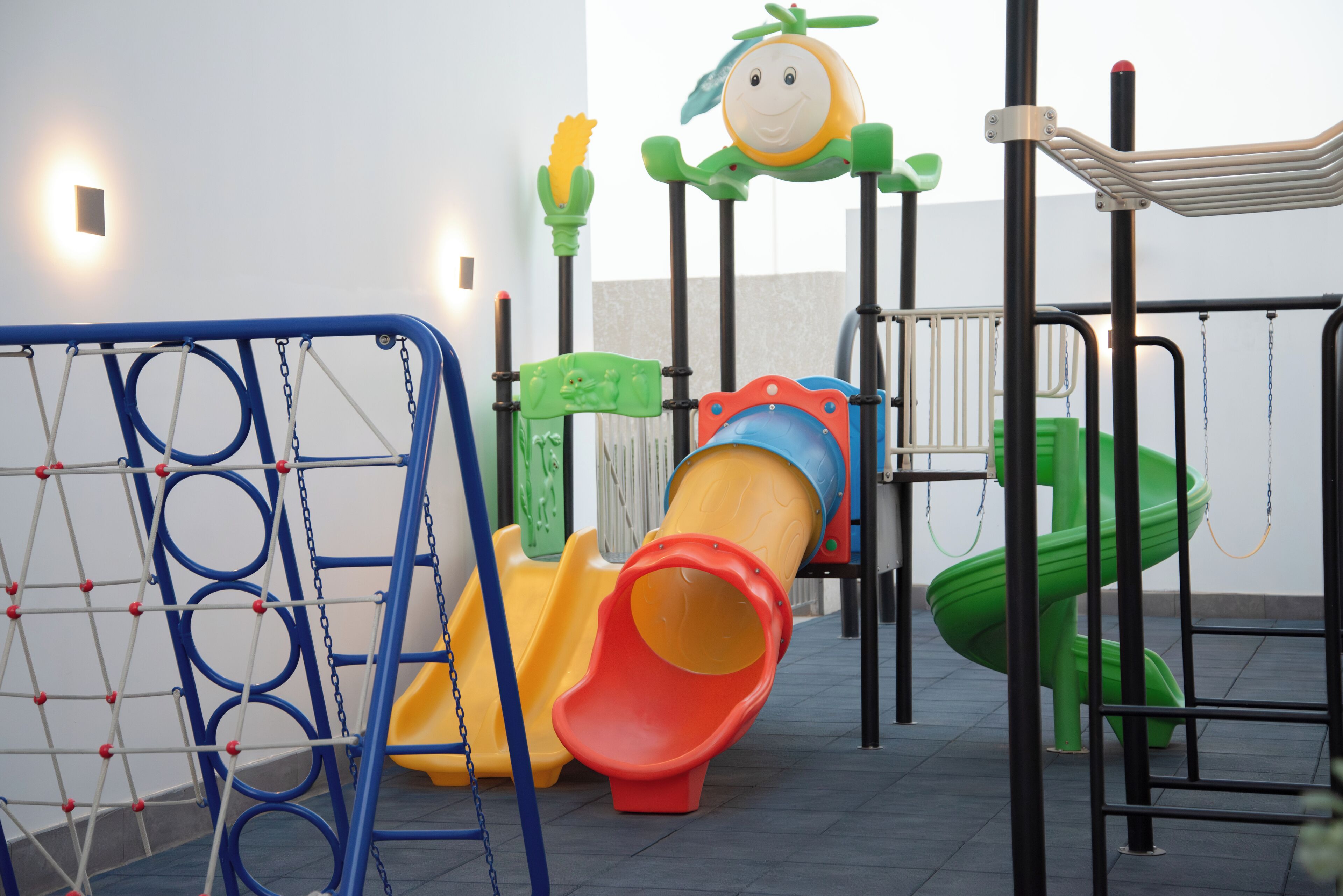 A children's play area with various slides and climbing structures.