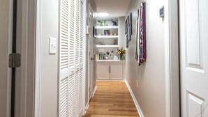 A hallway with white doors, wooden flooring, and a ceiling light. - Feels Like Home - Close to Downtown! (Raleigh)