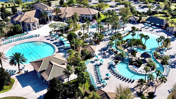 A resort with a large central pool, multiple smaller pools, and a well-maintained landscape with palm trees. - South-Facing Pool & Spa • Game Room • Conservation View • Near Disney (Four Corners)