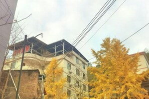 A multi-story building with visible windows and a curved roofline. - Wang Xing Hotel (Nanxiong)