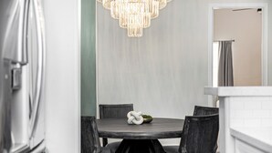 A dining area with a round table, four chairs, and a chandelier. - New Property TPC Golf Course | 4 Beds | Golf Dream (Scottsdale)