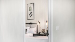 A neatly made bed with white linens, a headboard, and two bedside lamps with clear shades. - New Property TPC Golf Course | 4 Beds | Golf Dream (Scottsdale)