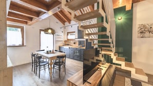 A modern kitchen with a dining area, wooden beams, and a staircase. - Sesto Senso - Three Bedroom Apartment, Sleeps 8 (Ponte di legno)