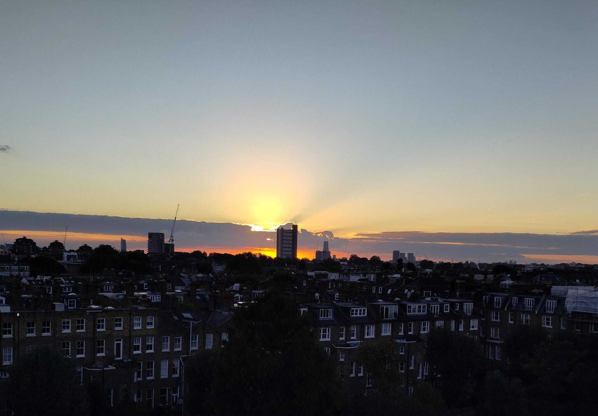 A residential area with multiple apartment buildings during sunset.