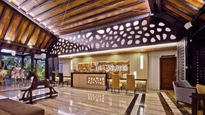 A hotel lobby with a reception desk, seating area, and a wooden ceiling. - Ijen Suites Resort & Convention (Klojen)