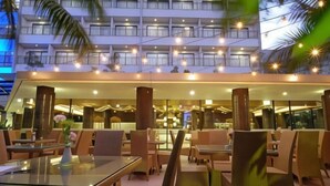 A modern hotel lobby with a spacious seating area, large windows, and a view of the building's exterior. - Ijen Suites Resort & Convention (Klojen)