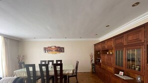 A dining area with a table and chairs, wooden cabinets, and a patterned floor. - Colonial House, beautifull spacious garden house  (La Paz)