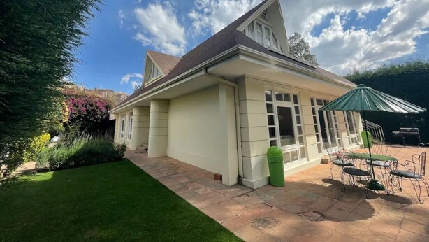 A house with a patio, a green lawn, and a garden. - Colonial House, beautifull spacious garden house  (La Paz)