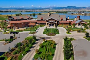 A modern hotel with a central courtyard, a lake view, and a mountain backdrop. - Colorado Modern Retreat w/ King Beds, Pickleball (Loveland)