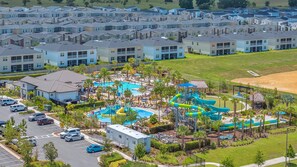A residential area with multiple apartment buildings, a swimming pool, and a water park.