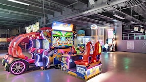 A brightly lit arcade with various gaming machines, including a prominent 'NERF' game. - 🌊Gulf Views-Great Amenities-Laketown Wharf 1523🌊 (Panama City Beach)