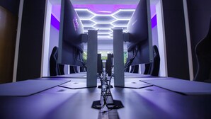 Une pièce moderne et symétrique, avec un bureau central et deux écrans d’ordinateur de chaque côté.