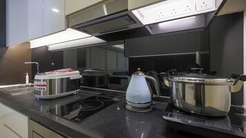 A modern kitchen with stainless steel appliances, a built-in oven, and a range hood.