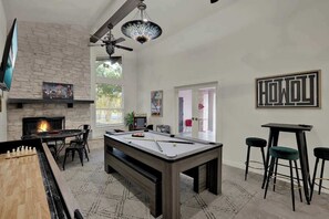 A cozy living room with a pool table, a fireplace, and a bar area. - Walk to Whitewater Amphitheater-GameRoom & Firepit (Canyon Lake)