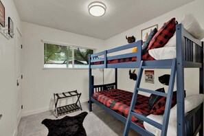 A bunk bed room with a window, a small rack, and a black rug. - Walk to Whitewater Amphitheater-GameRoom & Firepit (Canyon Lake)