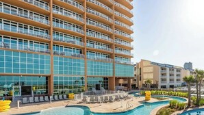 A hotel with a large pool area, multiple balconies, and a modern architectural design. - Brand New Phoenix Gulf Tower 2507 /Lazy River/Beach
Your Vacation Getaway! (Orange Beach)