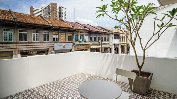 A rooftop terrace with a tiled floor, a small round table, and a potted plant. - Hutton Central Hotel Managed By The Ascott Limited  (George Town)