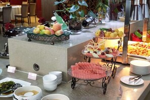 A buffet with various food items and dishes. - UPLS Hotel (Zhongwei)