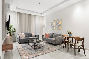 Comfort Apartment | Living area | 50-inch Smart TV with cable channels - Silkhaus Sayl 25 (Riyadh)
