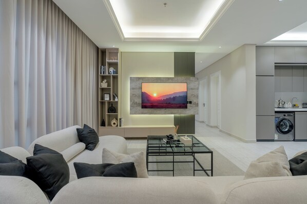 Signature Apartment | Living area | 50-inch Smart TV with digital channels