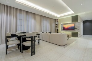 Signature Apartment | Living area | 50-inch Smart TV with digital channels
