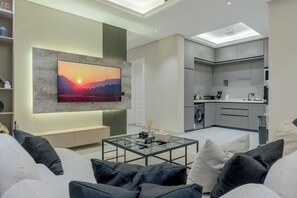 Signature Apartment | Living area | 50-inch Smart TV with digital channels