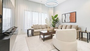A modern living room with a sofa, coffee table, and TV stand. - Silkhaus Majidia 139 (Riyadh)