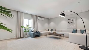 A modern living room with a sofa, armchair, coffee table, and floor lamp. - Silkhaus Majidia156 (Riyadh)