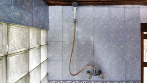 A shower with a hose, tiled walls, and a wooden ceiling. - Bagus Bay Homestay (Tuktuk Siadong)